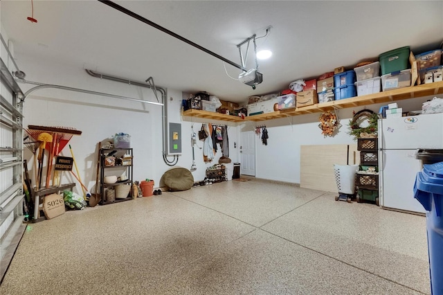 5026 Bromeliad Ave, Wimauma, FL 33598 - garage featuring freestanding refrigerator, a garage door opener, and electric panel