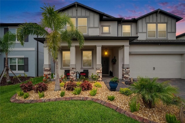 5026 Bromeliad Ave, Wimauma, FL 33598 - view of front facade featuring stucco siding, a garage, covered porch, and driveway