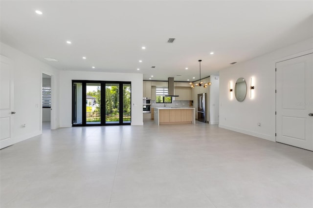 3578 NE 9th Pl, Cape Coral, FL 33909 - unfurnished living room featuring recessed lighting, baseboards, and a chandelier