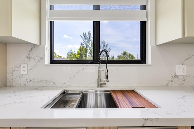 3578 NE 9th Pl, Cape Coral, FL 33909 - kitchen view of a sink, decorative backsplash, and white cabinets