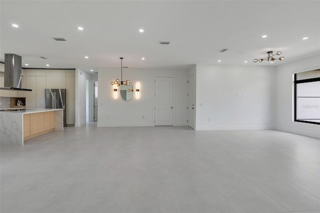 3578 NE 9th Pl, Cape Coral, FL 33909 - unfurnished living room featuring a chandelier, recessed lighting, light tile patterned flooring, and baseboards
