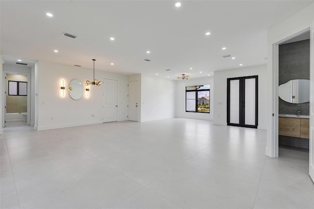 3578 NE 9th Pl, Cape Coral, FL 33909 - unfurnished living room with a chandelier, recessed lighting, light tile patterned floors, and baseboards