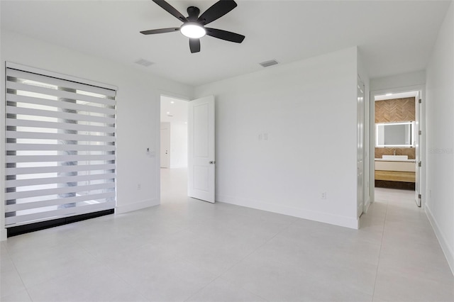3578 NE 9th Pl, Cape Coral, FL 33909 - empty room with a ceiling fan, light tile patterned floors, and baseboards