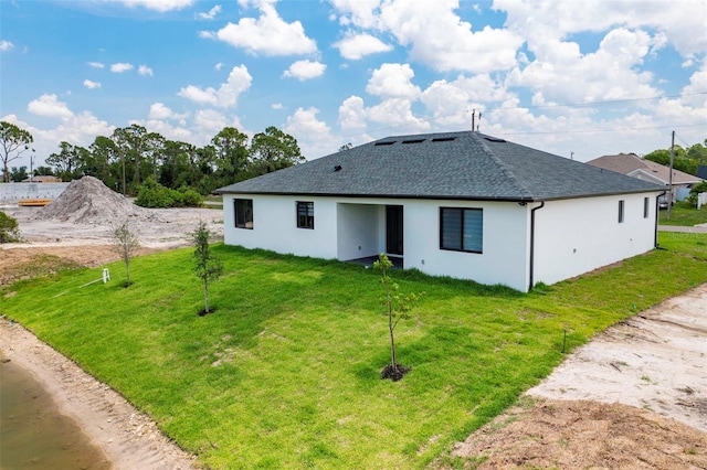 3578 NE 9th Pl, Cape Coral, FL 33909 - back of house featuring stucco siding, roof with shingles, and a lawn