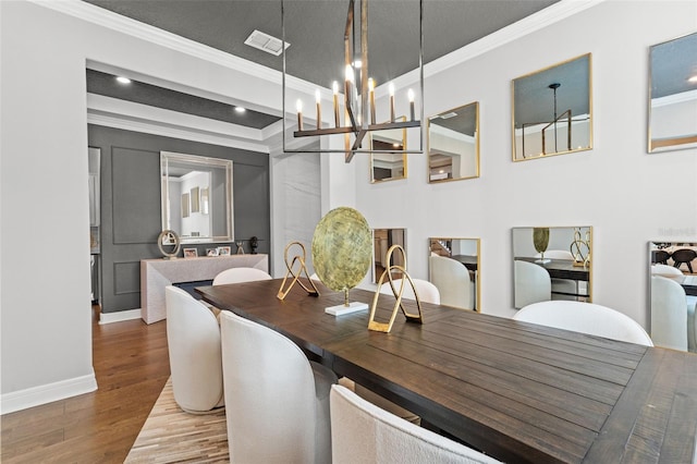 13859 Sharp Hawk Dr, Riverview, FL 33569 - dining room featuring crown molding, wood finished floors, a chandelier, baseboards, and recessed lighting