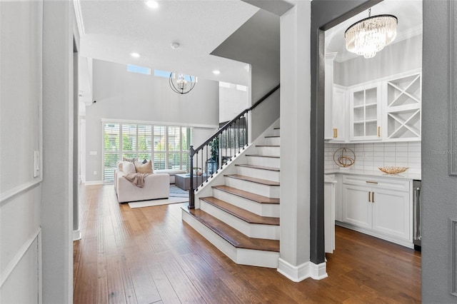 13859 Sharp Hawk Dr, Riverview, FL 33569 - stairs with a chandelier, wood finished floors, recessed lighting, and baseboards