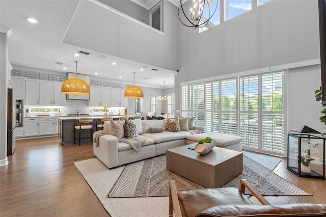 13859 Sharp Hawk Dr, Riverview, FL 33569 - living area with a chandelier, plenty of natural light, wood finished floors, ornamental molding, and recessed lighting