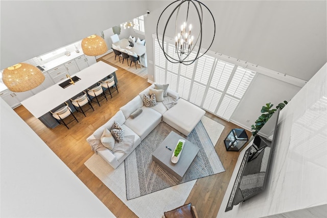 13859 Sharp Hawk Dr, Riverview, FL 33569 - living area with a chandelier, wood finished floors, and a high ceiling