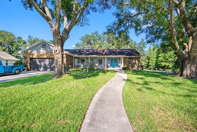 11109 Winn Rd, Riverview, FL 33569 - ranch-style house with covered porch, an attached garage, concrete driveway, and a front yard