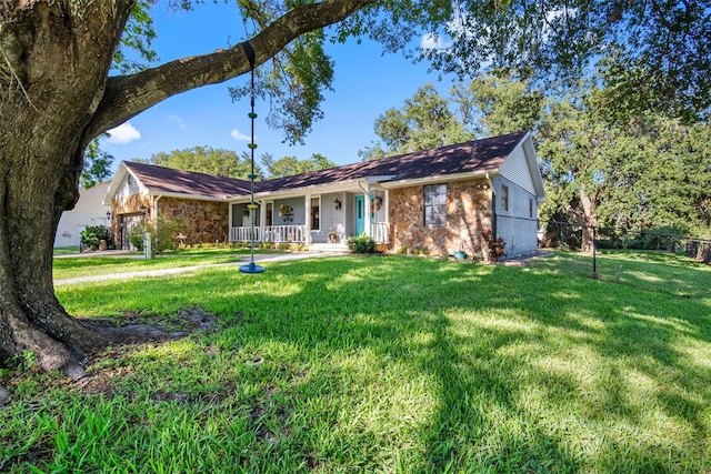 11109 Winn Rd, Riverview, FL 33569 - ranch-style home with covered porch, an attached garage, and stone siding