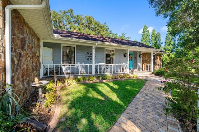 11109 Winn Rd, Riverview, FL 33569 - single story home with a porch, a front lawn, and stone siding