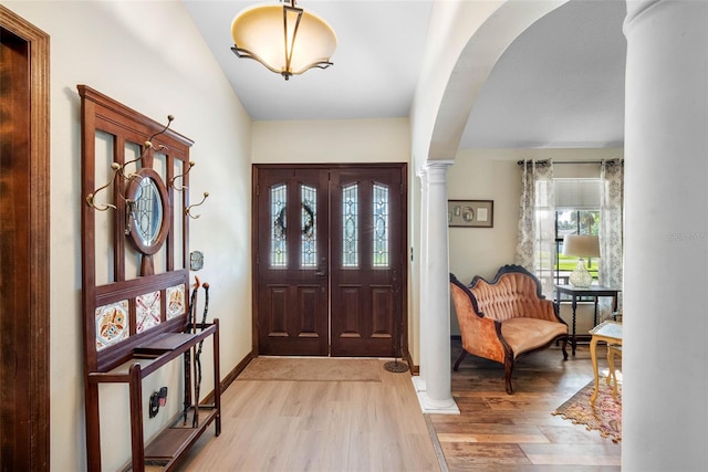 11109 Winn Rd, Riverview, FL 33569 - entryway with light wood-style floors, decorative columns, arched walkways, and baseboards