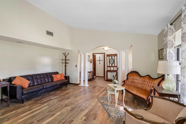 11109 Winn Rd, Riverview, FL 33569 - living area featuring ornate columns, wood finished floors, arched walkways, and high vaulted ceiling