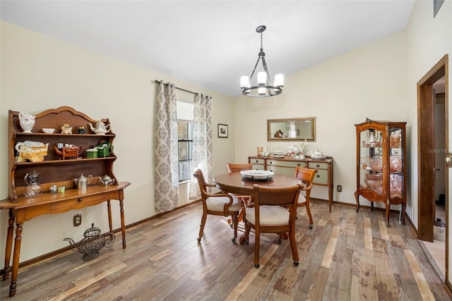 11109 Winn Rd, Riverview, FL 33569 - dining space featuring a chandelier, light wood-type flooring, vaulted ceiling, and baseboards