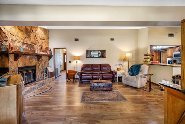 11109 Winn Rd, Riverview, FL 33569 - living room featuring hardwood / wood-style floors and a stone fireplace