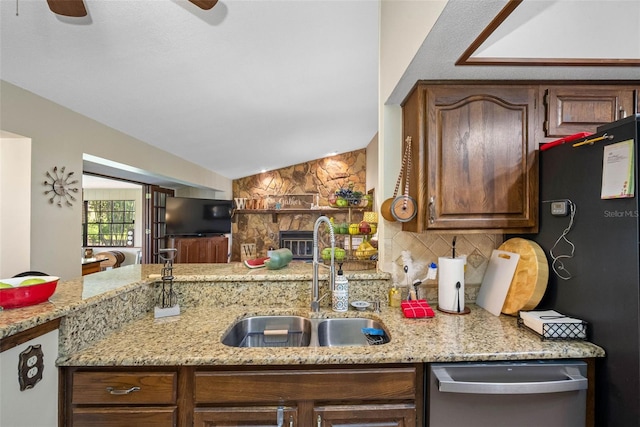11109 Winn Rd, Riverview, FL 33569 - kitchen featuring a sink, stainless steel dishwasher, tasteful backsplash, a stone fireplace, and ceiling fan