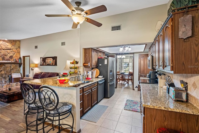 11109 Winn Rd, Riverview, FL 33569 - kitchen with stainless steel appliances, a sink, open floor plan, a ceiling fan, and a kitchen breakfast bar