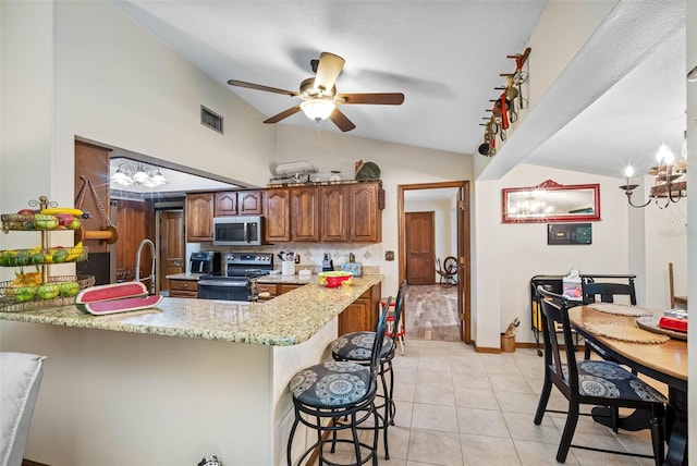 11109 Winn Rd, Riverview, FL 33569 - kitchen featuring appliances with stainless steel finishes, vaulted ceiling, a chandelier, a peninsula, and ceiling fan