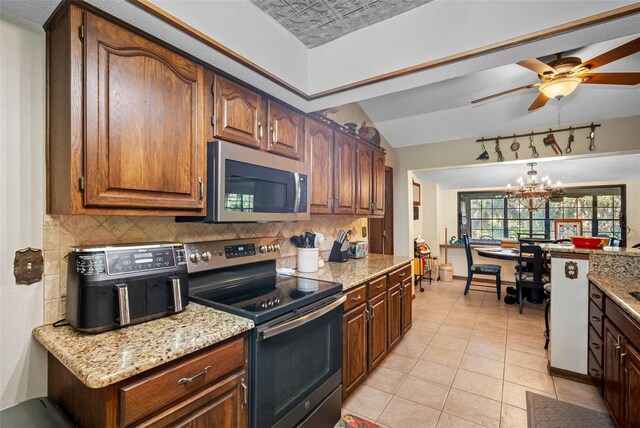 11109 Winn Rd, Riverview, FL 33569 - kitchen with appliances with stainless steel finishes, tasteful backsplash, light tile patterned floors, a ceiling fan, and lofted ceiling