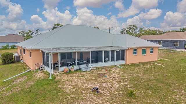 5432 Queen Ave, Spring Hill, FL 34609 - rear view of property featuring a sunroom, a lawn, central AC, and stucco siding