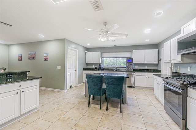 5432 Queen Ave, Spring Hill, FL 34609 - kitchen featuring stainless steel appliances, a ceiling fan, white cabinetry, a sink, and light tile patterned floors