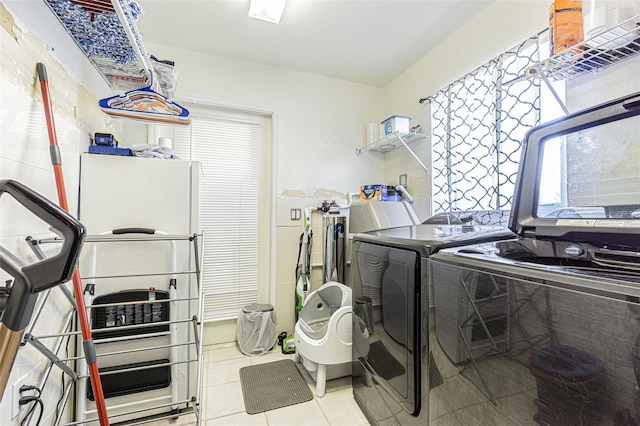 5432 Queen Ave, Spring Hill, FL 34609 - laundry room featuring separate washer and dryer, tile patterned flooring, and healthy amount of natural light