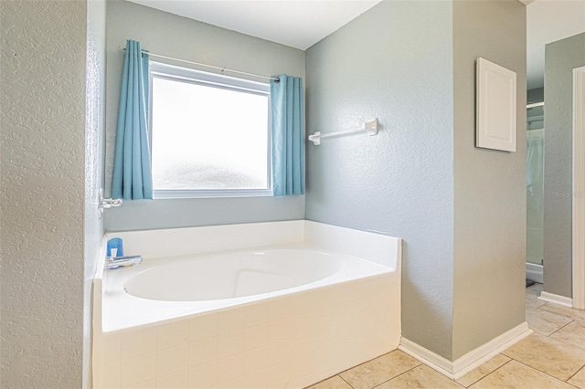 5432 Queen Ave, Spring Hill, FL 34609 - bathroom featuring a garden tub, tile patterned flooring, a textured wall, and a shower