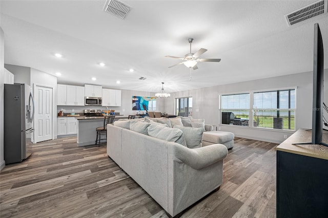31775 Sun Kettle Loop, Wesley Chapel, FL 33545 - living area with ceiling fan, wood finished floors, recessed lighting, a chandelier, and baseboards