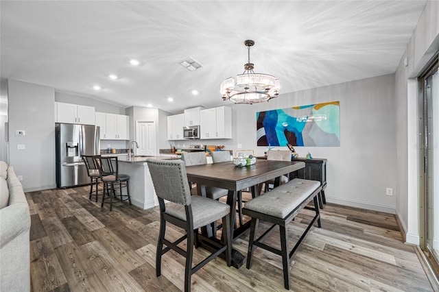 31775 Sun Kettle Loop, Wesley Chapel, FL 33545 - dining room featuring a chandelier, wood finished floors, recessed lighting, vaulted ceiling, and baseboards
