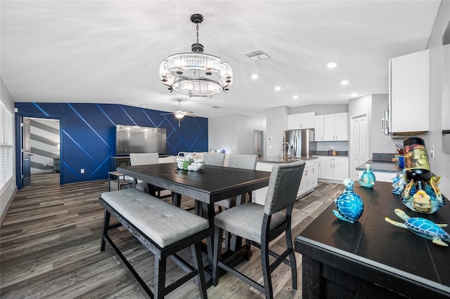 31775 Sun Kettle Loop, Wesley Chapel, FL 33545 - dining space featuring wood finished floors, a chandelier, a ceiling fan, recessed lighting, and an accent wall