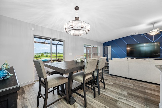 31775 Sun Kettle Loop, Wesley Chapel, FL 33545 - dining area with wood finished floors, a chandelier, ceiling fan, lofted ceiling, and baseboards