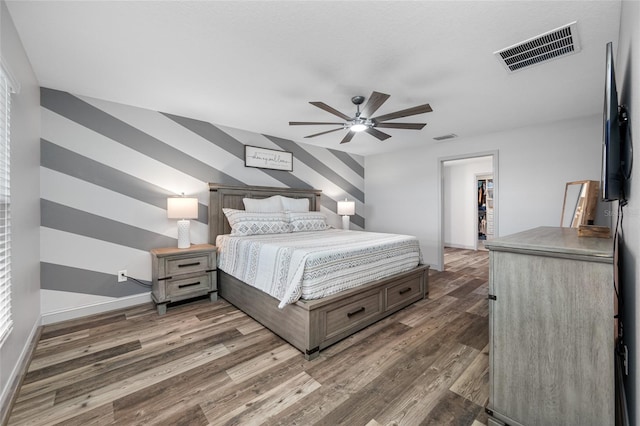 31775 Sun Kettle Loop, Wesley Chapel, FL 33545 - bedroom with wood finished floors, baseboards, a walk in closet, and ceiling fan
