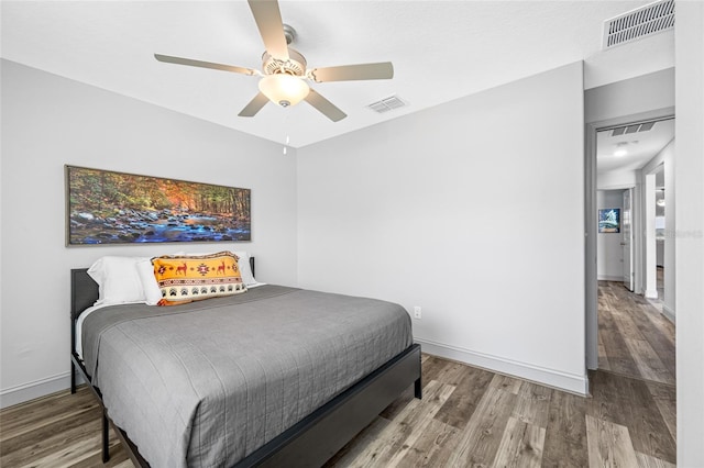 31775 Sun Kettle Loop, Wesley Chapel, FL 33545 - bedroom with wood finished floors, a ceiling fan, and baseboards
