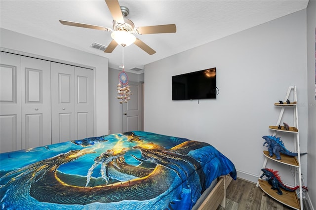 31775 Sun Kettle Loop, Wesley Chapel, FL 33545 - bedroom featuring wood finished floors, a ceiling fan, a closet, and baseboards