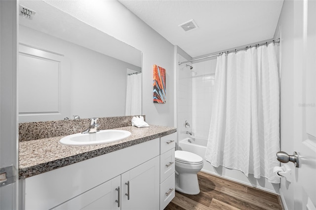 31775 Sun Kettle Loop, Wesley Chapel, FL 33545 - bathroom featuring toilet, vanity, wood finished floors, and shower / bath combination with curtain