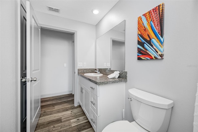31775 Sun Kettle Loop, Wesley Chapel, FL 33545 - half bathroom with vanity, wood finished floors, and toilet