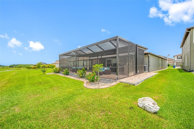 31775 Sun Kettle Loop, Wesley Chapel, FL 33545 - rear view of property featuring a patio, a lawn, glass enclosure, and central AC unit