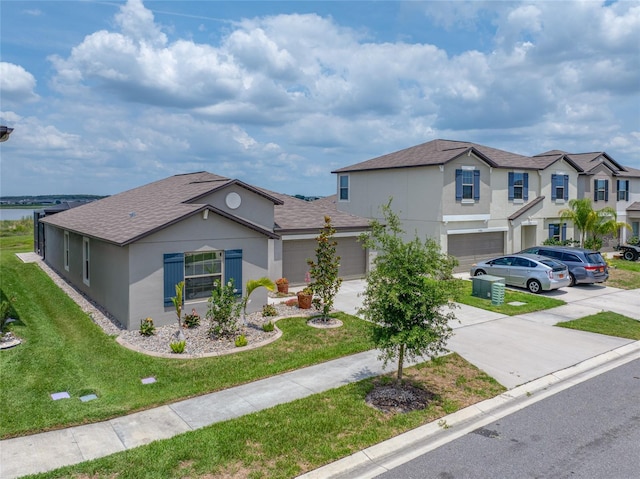 31775 Sun Kettle Loop, Wesley Chapel, FL 33545 - view of front of house featuring concrete driveway, stucco siding, an attached garage, a front lawn, and roof with shingles