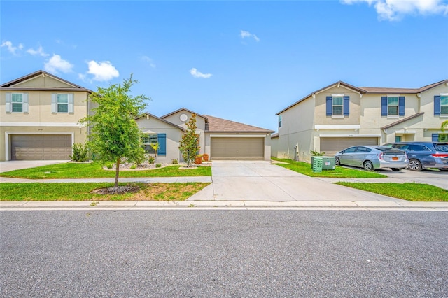 31775 Sun Kettle Loop, Wesley Chapel, FL 33545 - view of front of house with a garage, stucco siding, and driveway