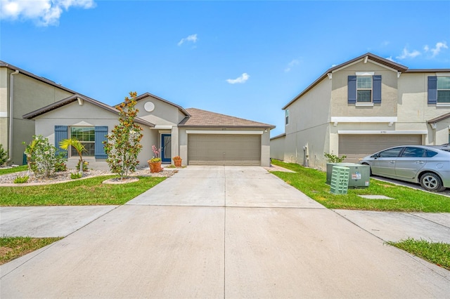 31775 Sun Kettle Loop, Wesley Chapel, FL 33545 - view of front of home featuring concrete driveway, an attached garage, stucco siding, and a front lawn