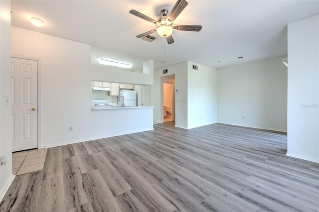 13025 Sanctuary Cove Dr Unit 301, Temple Terrace, FL 33637 - unfurnished living room with a ceiling fan, light wood-style flooring, and baseboards