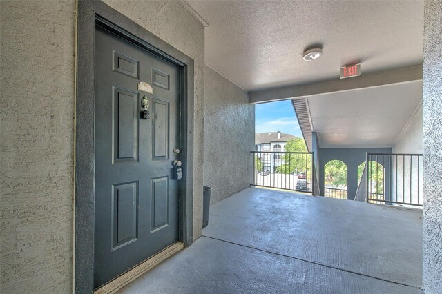 13025 Sanctuary Cove Dr Unit 301, Temple Terrace, FL 33637 - property entrance with stucco siding and a balcony