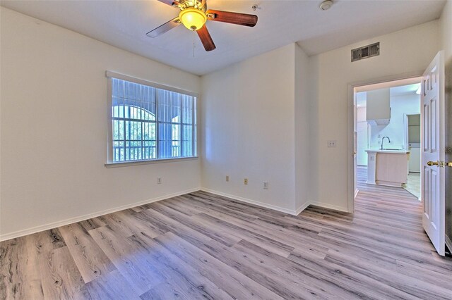 13025 Sanctuary Cove Dr Unit 301, Temple Terrace, FL 33637 - unfurnished room with light wood finished floors, a sink, baseboards, and ceiling fan