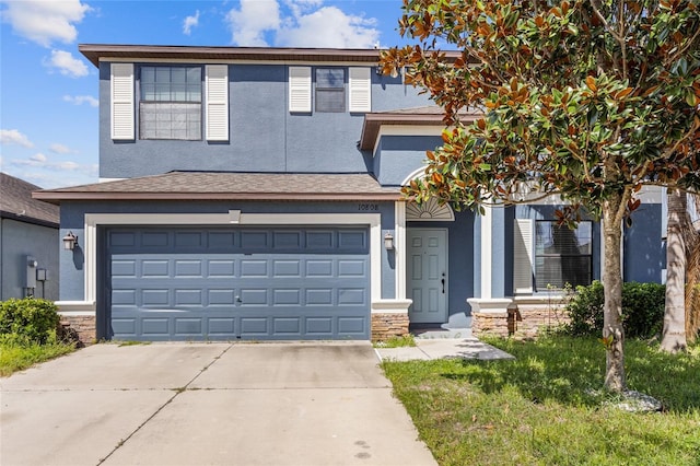 10808 Whitecap Dr, Riverview, FL 33579 - view of front facade featuring stucco siding, concrete driveway, an attached garage, and stone siding