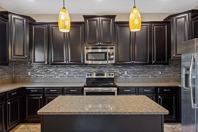 10808 Whitecap Dr, Riverview, FL 33579 - kitchen with stainless steel appliances, light tile patterned flooring, and decorative light fixtures