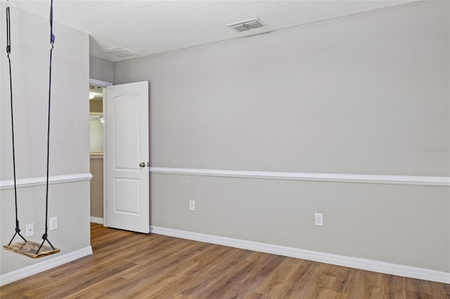 10808 Whitecap Dr, Riverview, FL 33579 - unfurnished room featuring wood finished floors and a textured ceiling