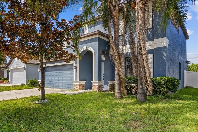 10808 Whitecap Dr, Riverview, FL 33579 - view of front of property with stucco siding, a front yard, concrete driveway, and an attached garage