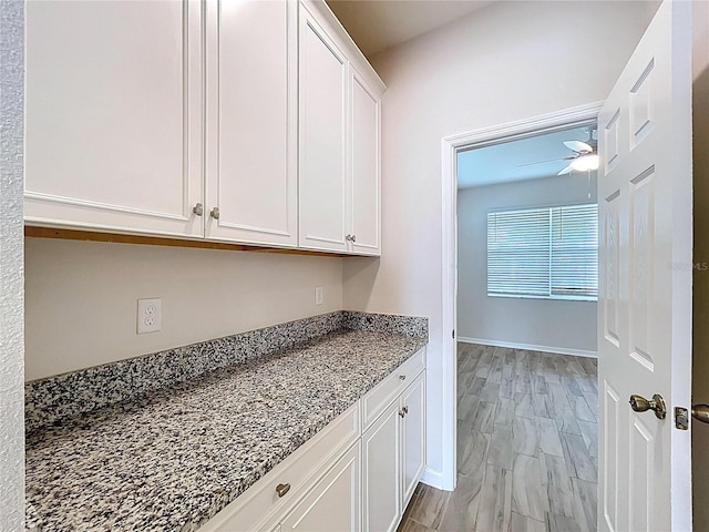 3063 Marine Grass Dr, Wimauma, FL 33598 - kitchen featuring white cabinetry, ceiling fan, and dark stone countertops