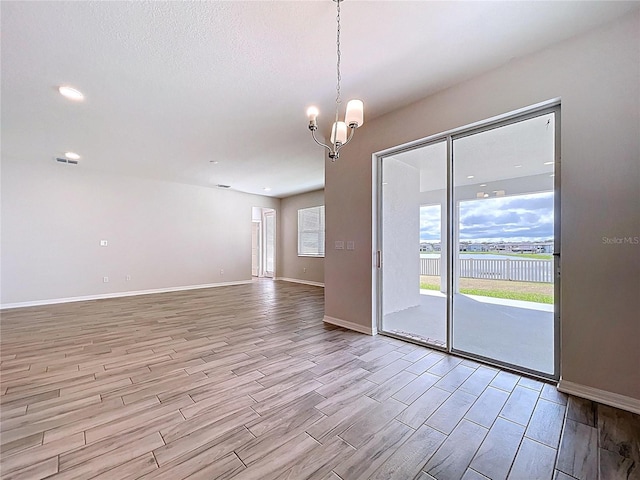 3063 Marine Grass Dr, Wimauma, FL 33598 - empty room with wood finished floors, baseboards, a chandelier, a water view, and recessed lighting