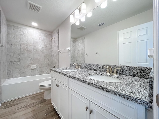 3063 Marine Grass Dr, Wimauma, FL 33598 - full bathroom with toilet, double vanity, wood tiled floors, and  shower combination